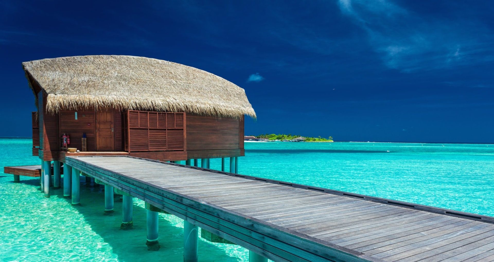 Over water bungalows with steps into coral lagoon, Maldives